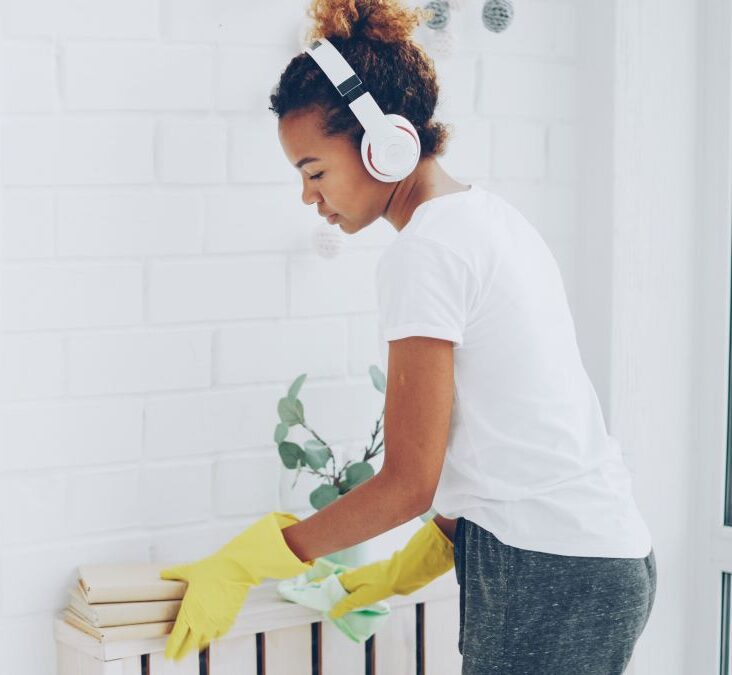 Young person cleaning with headphones