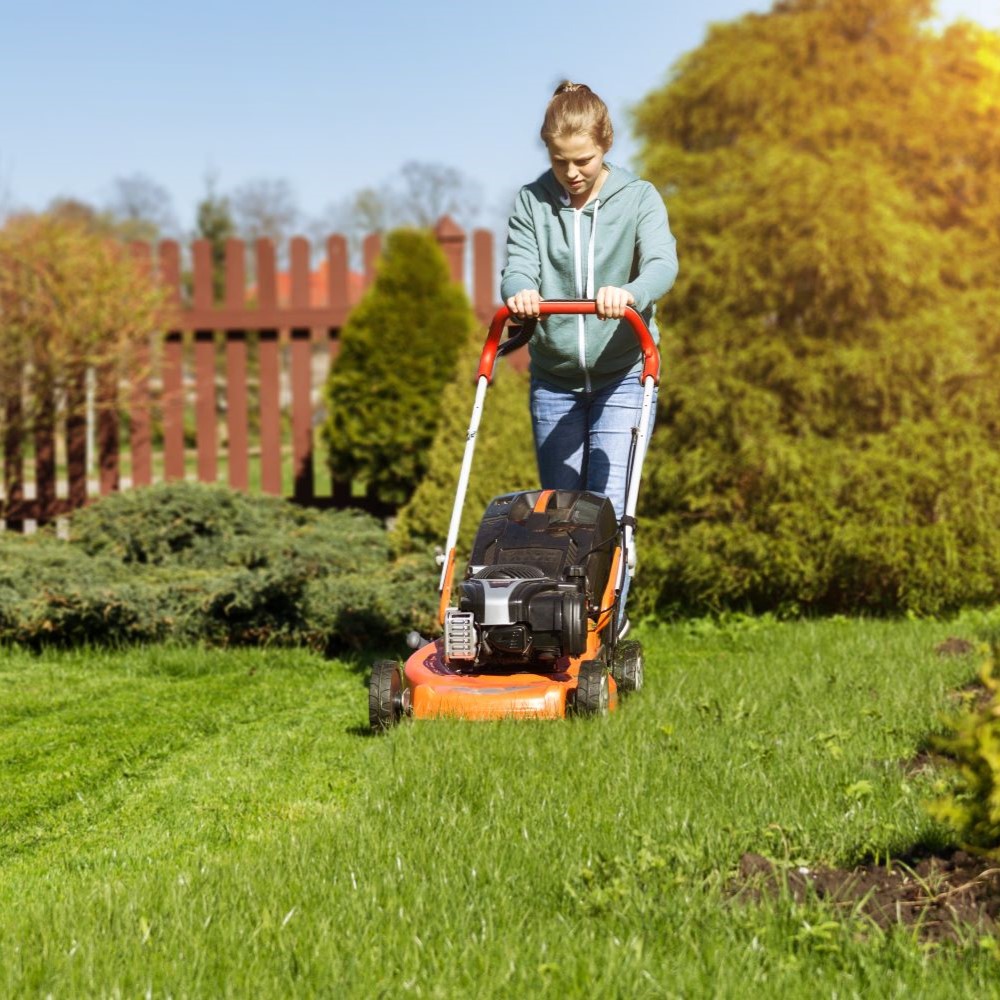 Young person mowing lawn